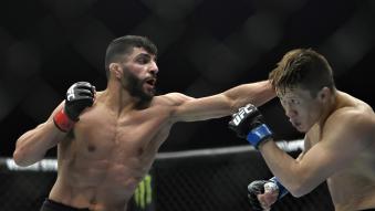 Amir Albazi of Iraq punches Zhalgas Zhumagulov of Kazakhstan in a flyweight fight during the UFC 257 event inside Etihad Arena on UFC Fight Island on January 23, 2021 in Abu Dhabi, United Arab Emirates. (Photo by Chris Unger/Zuffa LLC)