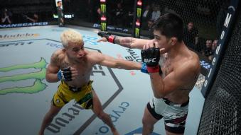 Daniel Santos of Brazil punches John Castaneda in a 140-pound catchweight fight during the UFC Fight Night event at UFC APEX