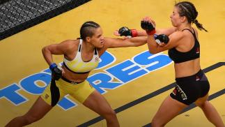 Amanda Nunes punches Miesha Tate during the UFC 200 event on July 9, 2016 at T-Mobile Arena in Las Vegas, Nevada. (Photo by Ed Mulholland/Zuffa LLC)