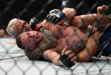 Charles Oliveira of Brazil secures a rear choke submission against Justin Gaethje in the UFC lightweight championship fight during the UFC 274 event at Footprint Center on May 07, 2022 in Phoenix, Arizona. (Photo by Jeff Bottari/Zuffa LLC)